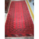 Middle Eastern red ground bokhara style runner. 259 x 110cm approx. (B.P. 21% + VAT)