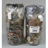 Two glass jars of assorted foreign coinage. (2) (B. P. 21% + VAT)