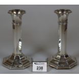 Pair of George V silver candlesticks with octagonal loaded bases. Birmingham hallmarks. 16cm high