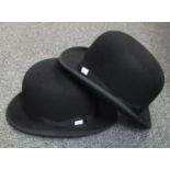 Two black bowler hats, one by Lincoln Bennett & Co. Hatters, Piccadilly, London, the other Unitas