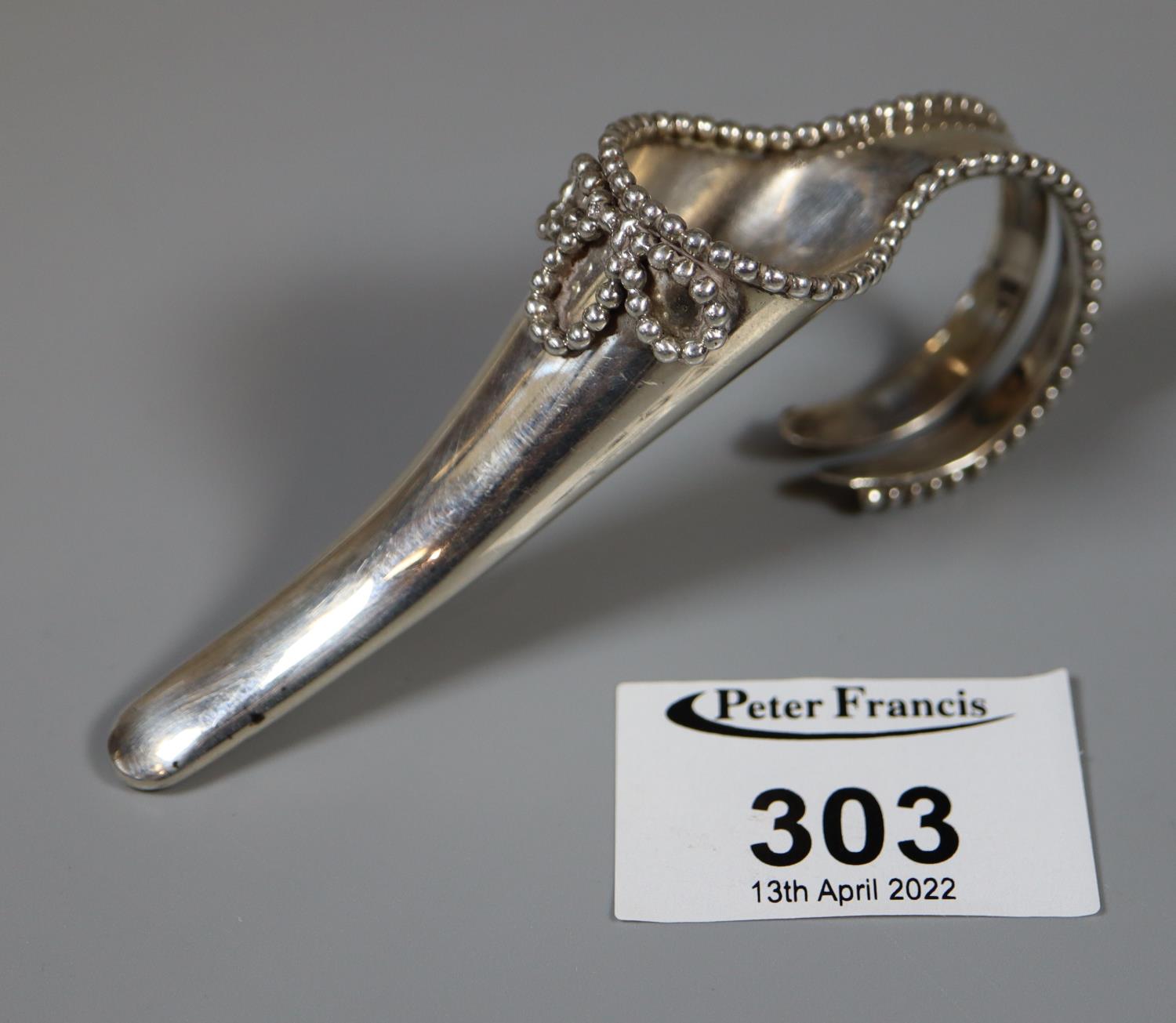 A silver corsage or florsl spray holder with beaded decoration and split handle by Garrards