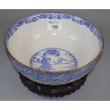 Japanese porcelain blue and white bowl with printed motif in a Chinese style, standing on a wooden