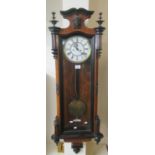 Early 20th century walnut ebonised two-train Vienna type wall clock with pendulum and key, and