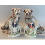 Pair of early 20th century Staffordshire pottery fireside seated pug dogs with glass eyes,