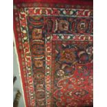 Large red ground Persian Mashad carpet with floral medallion designs. 392 x 370cm approximately. (