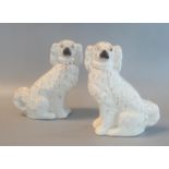 Pair of Staffordshire pottery seated fireside spaniels with painted features. (2) (B.P. 21% + VAT)