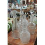 Six cut glass and moulded glass decanters to include: claret decanter, square whisky decanter,