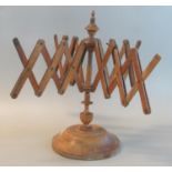 19th century extending walnut line or wool winder on turned circular base. (B.P. 21% + VAT)