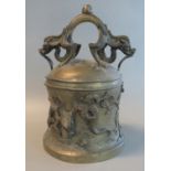 Yellow metal Oriental temple style bell, decorated with a dragon and Buddhist symbols, with two