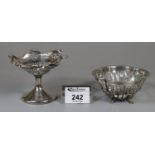 Two silver bonbon dishes, one on a loaded pedestal base, the other on paw feet. Chester and