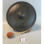 Metal gong with striker. 37cm diameter approx. (B.P. 21% + VAT) Possibly bronze