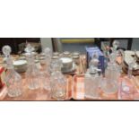 Two trays of cut and moulded glass decanters to include a cut glass claret decanter, baluster shaped