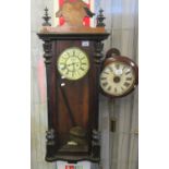 Early 20th century walnut two-train Vienna type wall clock with key and pendulum. Distressed