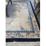 Chinese cream ground floral decorated wash rug with banded border and central foliate decoration.