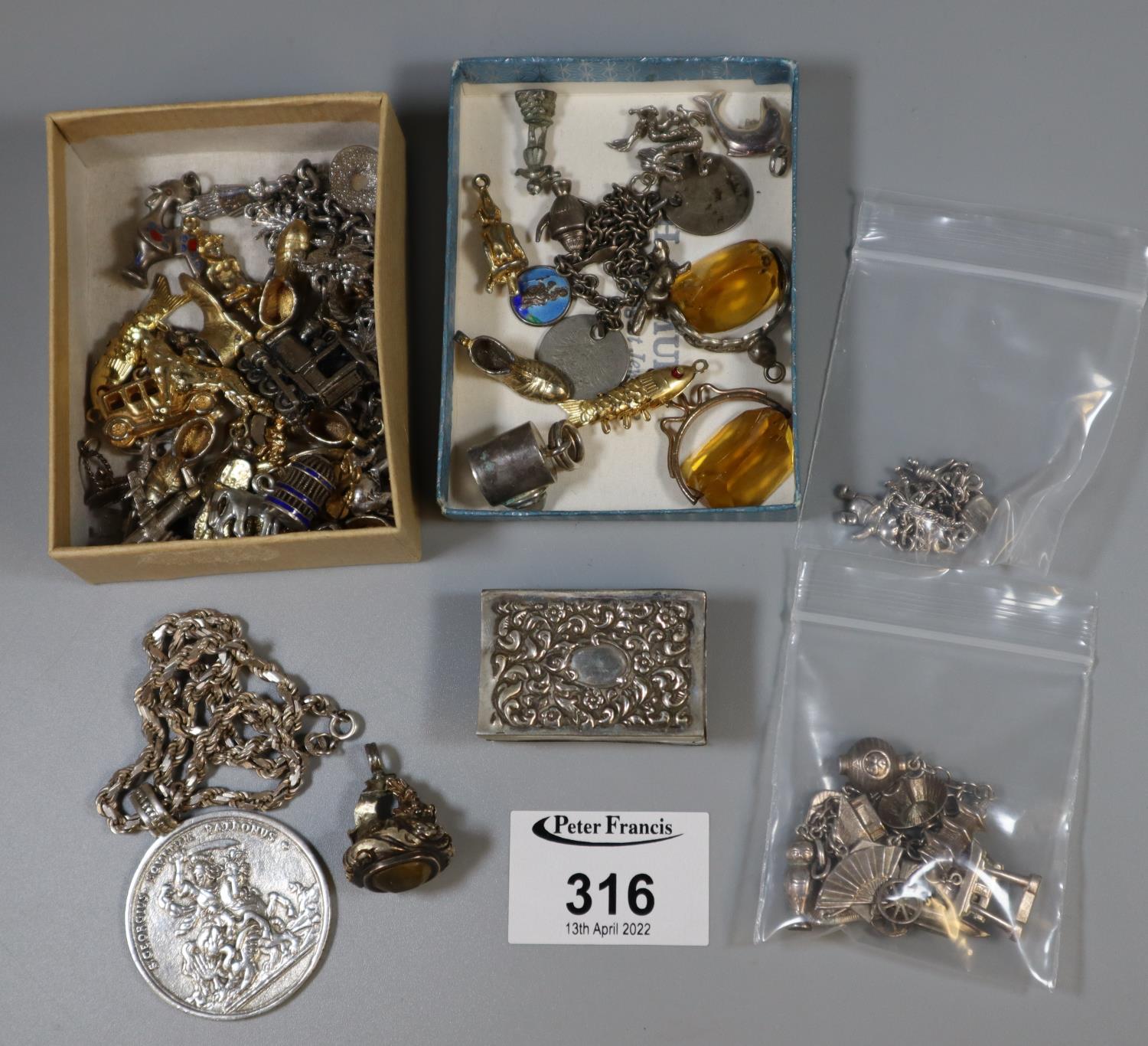 A collection of silver and costume jewellery including a Pooh Bear charm bracelet, silver match