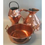 Large 19th century copper conical jug, together with another copper jug with iron handle, and a