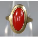 Yellow metal ring set with an oval red stone. Ring size J. Approx weight 2.1 grams. (B.P. 21% + VAT)