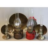 Group of four (a pair and two others) single burner oil lamps of differing sizes with reflectors and