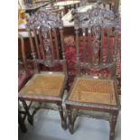Pair of late Victorian carved oak high back cane chairs on tapering fluted front legs (2). (B.P. 21%