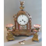 19th century French ormulu two train clock garniture, the arch case surmounted by a bust of