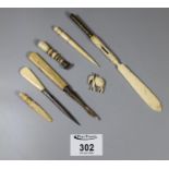 A collection of bone handled items including letter opener, an elephant model and a floral seal etc.