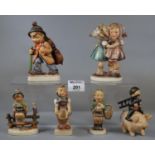 Collection of six Hummel figurines and figure groups to include boy with pig, boy with cello, girl