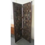 Good quality mahogany framed two fold screen decorated with studded panels of probably natural furs.