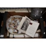 Box to include a two-handled plated trophy presentation cup, various coins, postcards, shipping