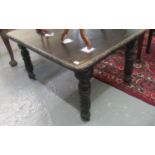 Late Victorian stained oak extending dining table on carved legs and castors. (B.P. 21% + VAT)