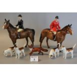 Beswick hunting group to include Huntsman and Huntswoman on horse back, four dogs, and a fox. (7) (