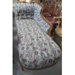 Late Victorian mixed woods upholstered chaise lounge on turned tapering legs and castors. (B.P.