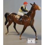 Beswick china horse and jockey in red cap and yellow and black top, no. 24 on the saddlecloth. (B.P.