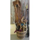 Wicker basket comprising a large collection of vintage fishing rods and equipment - landing net,