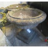 Pair of weathered composition circular pedestal garden urns on square bases - 56cm diameter (2) (B.