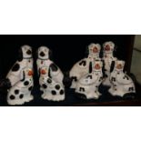 Collection of Staffordshire fire side seated spaniels, reproduction Burleigh Staffordshire dogs,