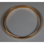 Yellow metal bangle. Tests as gold. Approx weight 14.5 grams. (B.P. 21% + VAT)