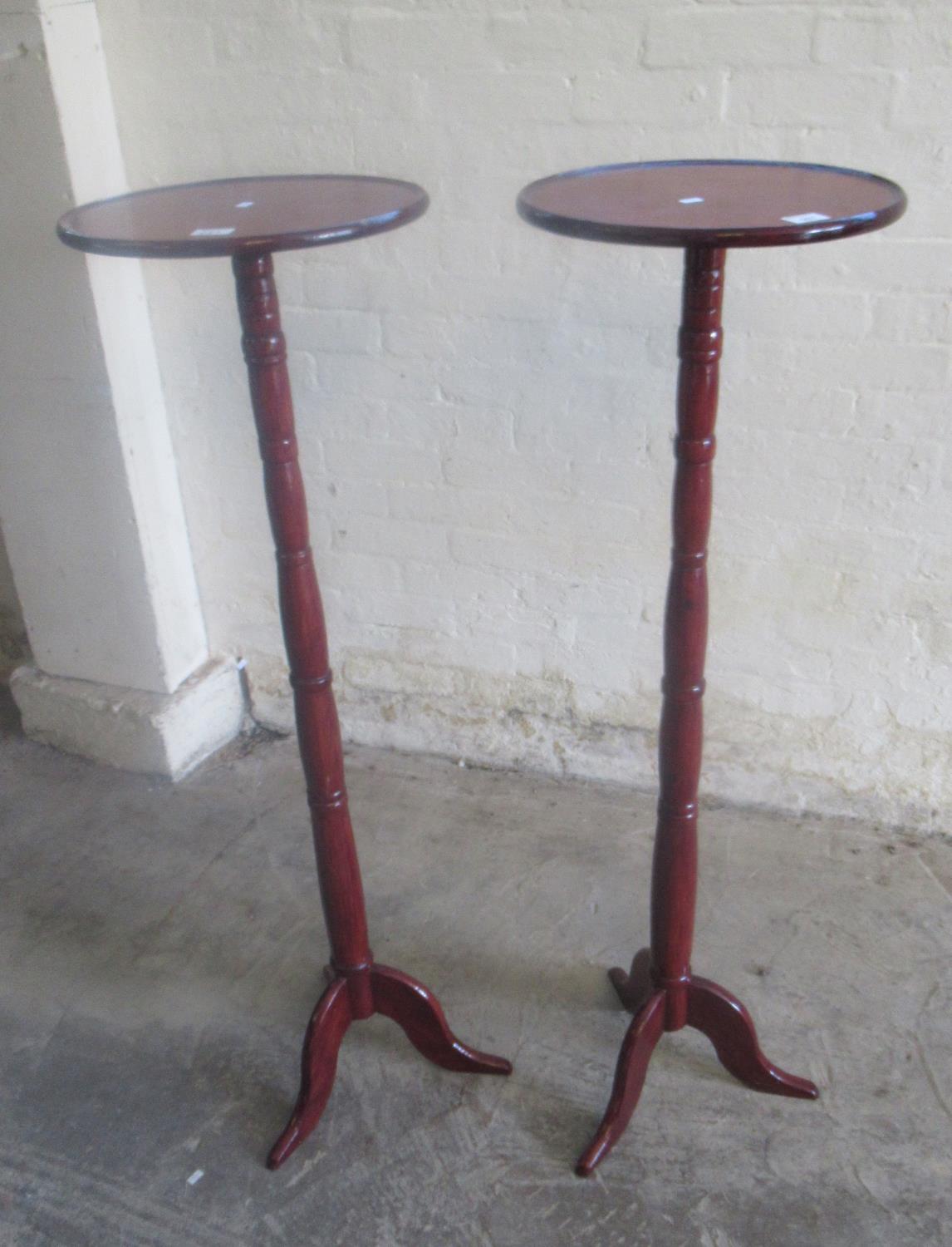 A pair of stained mahogany tripod torchere stands (2) (B.P. 21% + VAT)