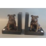 Pair of wooden book ends with ebonised finish, mounted with carved wooden seated bull dogs having
