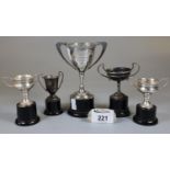 Collection of miniature silver plated two-handled trophy cups on ebonised socle bases. (5) (B. P.