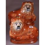 Pair of early 20th Century Sadler Burslem pottery recumbent fireside lions with glass eyes and