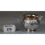 Victorian silver repousse single handled cream jug with gilded interior, Birmingham hallmarks,