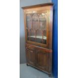 Early 19th centruy Welsh oak two stage corner cupboard with glazed single door top having three