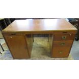 Early 20th century teak campaign style kneehole desk with pullout writing area, and brass recessed