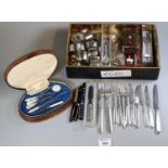 Box containing assorted souvenir spoons, silver plated napkins rings, loose plated cutlery,