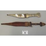 Two small Middle Eastern daggers, one with white metal foliate design covering to the scabbard and