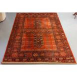 Large middle eastern design red ground carpet having geometric floral and foliate designs