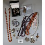 A collection of silver and gemstone bead jewellery including amber and carnelian beads and a white