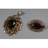 9ct gold smokey quartz pendant and a 9ct gold smokey quartz brooch. (B.P. 21% + VAT)
