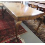 Early 20th century walnut serpentine shaped table on carved shell and cabriole legs with pad