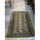Middle eastern design runner on a mustard ground with central geometric medallions together with